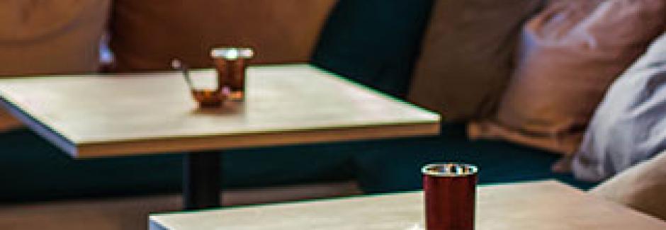 Close up of two tables with candles on them