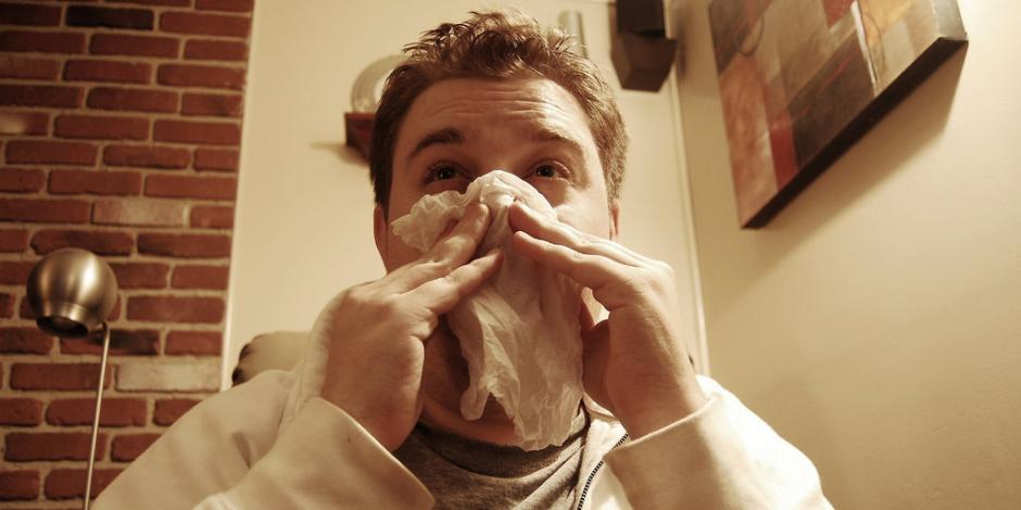 Man wiping nose