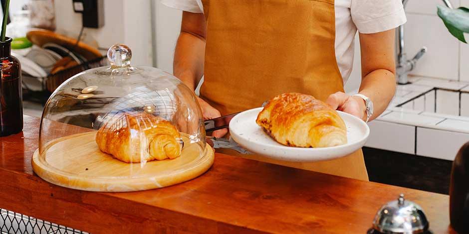 Restaurant worker serving delicious bread