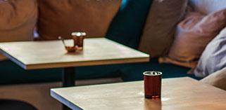 Close up of two tables with candles on them