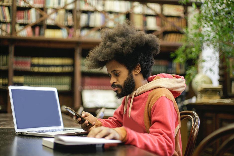 Man on phone by computer