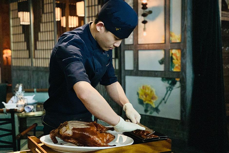 Person cutting cooked duck