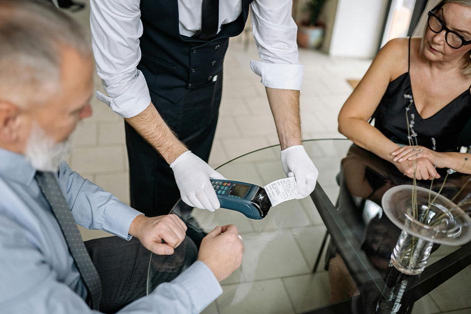 Two People Paying at a Restaurant