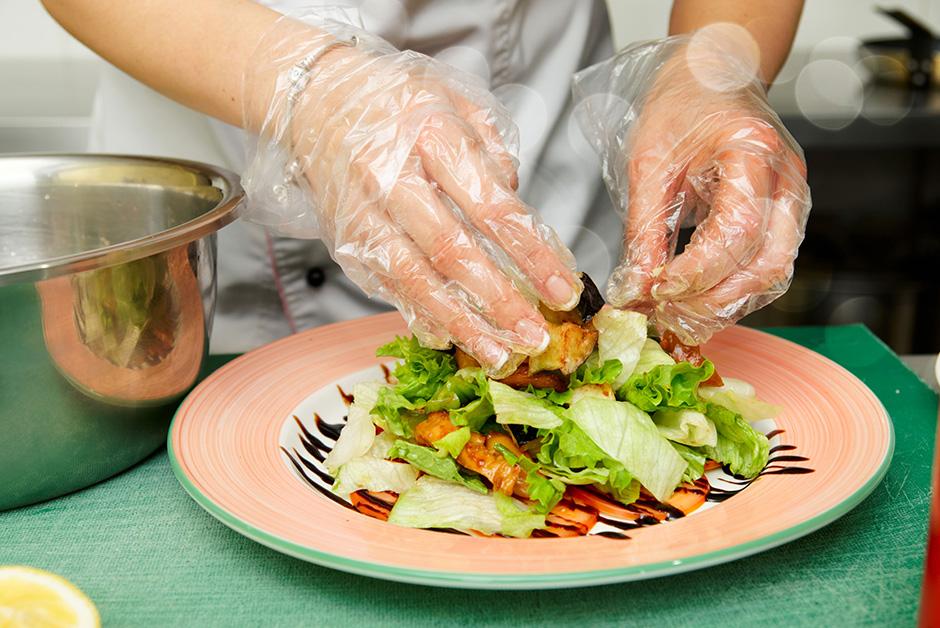 Preparing salad with gloves