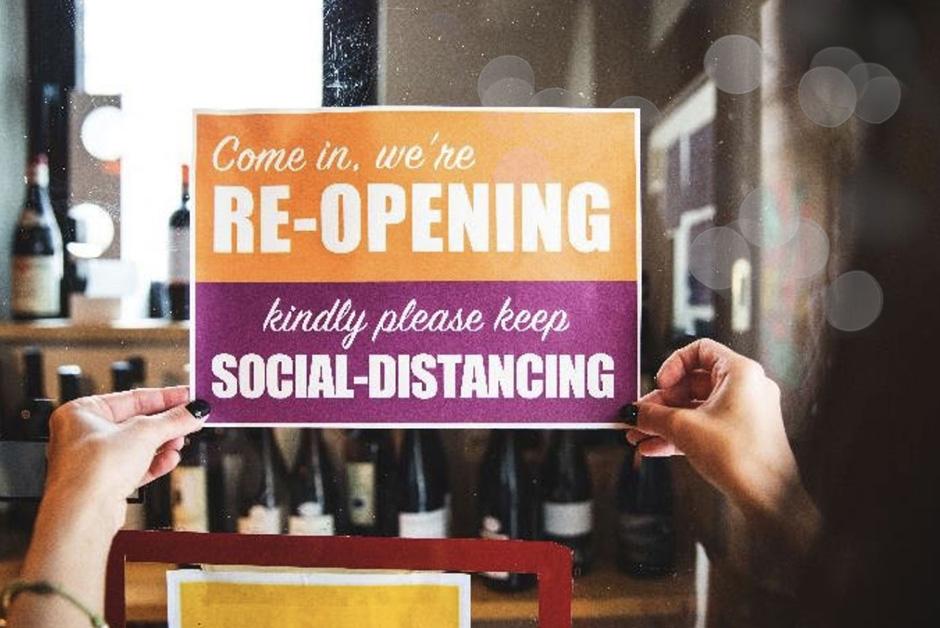 Person hanging sign in restaurant