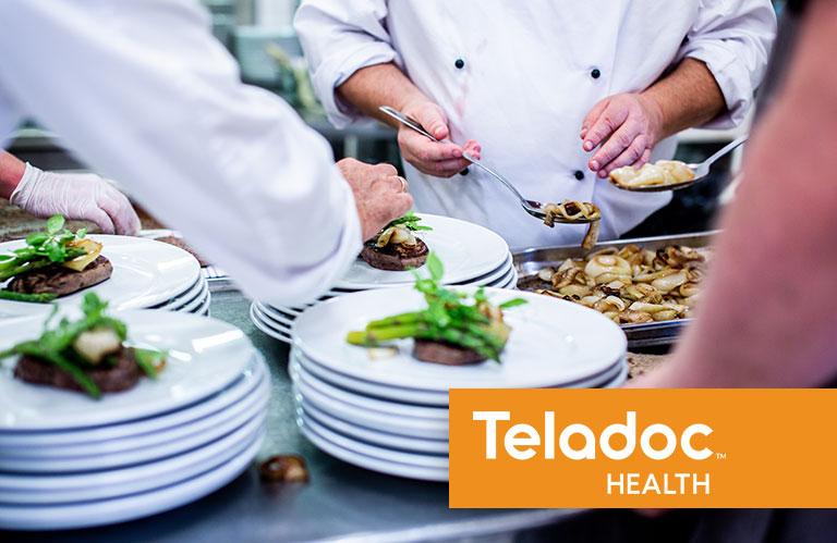 Chefs working on plating food
