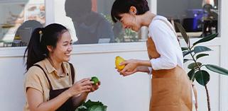 Happy Women Holding Fresh Fruits