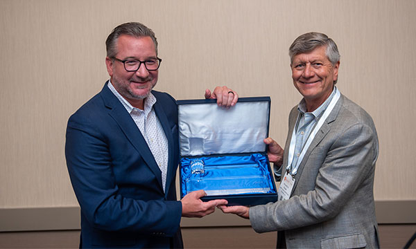 Gary Maggetti, outgoing CRA Board Chairman, left, hands the gavel to incoming Board Chairman Richard Frank, right.